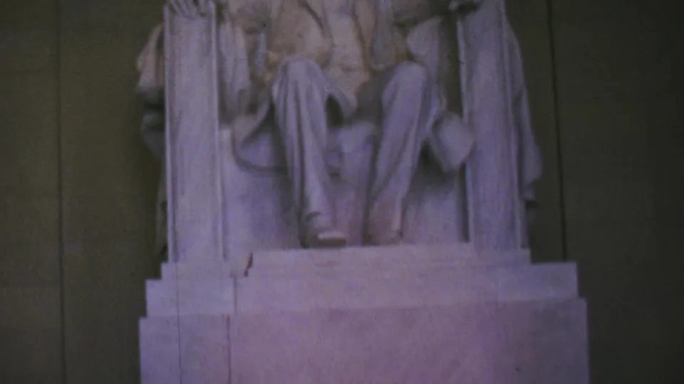 Frame from the Washington, DC home movie showing the lower portion of the seated Lincoln statue and its pedestal inside the memorial.
