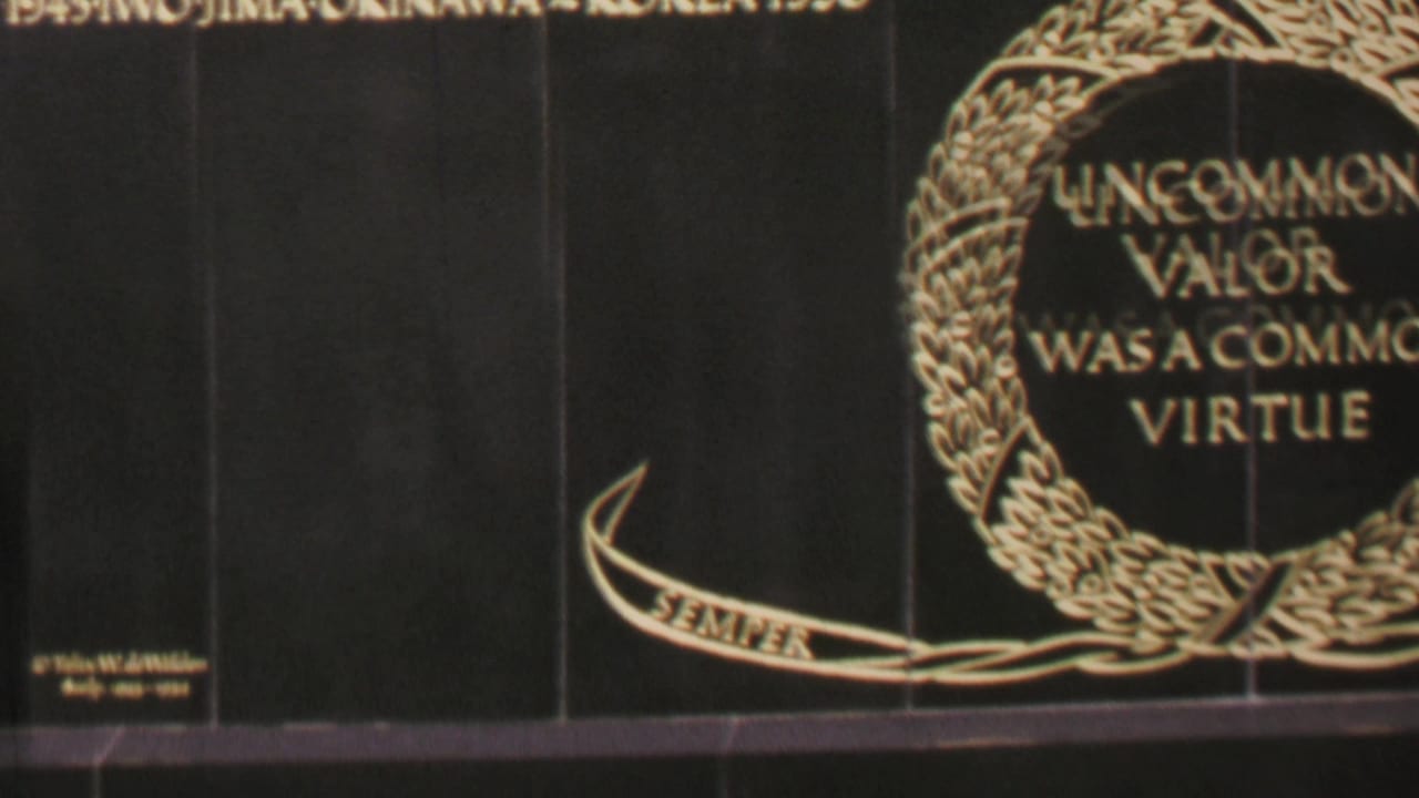 1969 Washington DC 8mm frame centered on a black granite memorial plaque with gold text reading “UNCOMMON VALOR WAS A COMMON VIRTUE” inside a laurel wreath and a ribbon below.