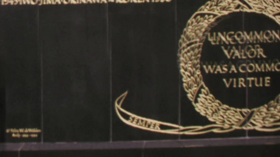 1969 Washington DC 8mm frame centered on a black granite memorial plaque with gold text reading “UNCOMMON VALOR WAS A COMMON VIRTUE” inside a laurel wreath and a ribbon below.