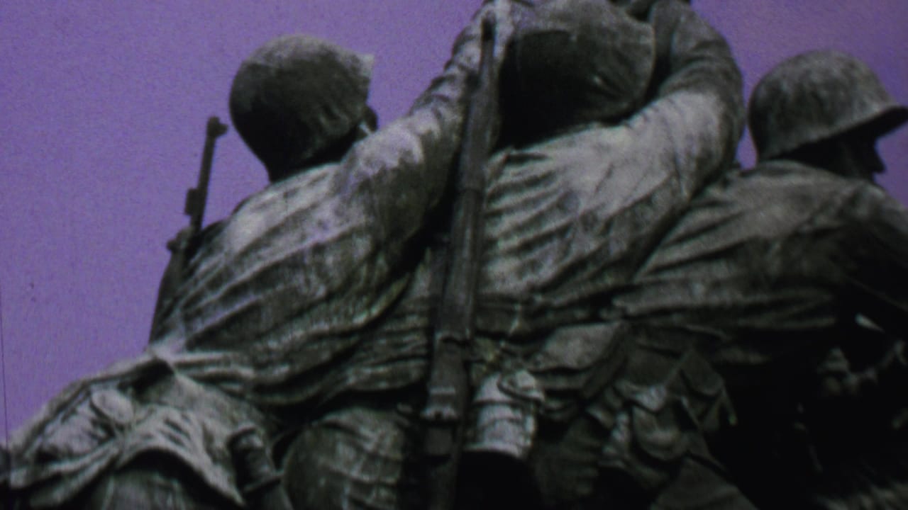Bronze military figures on the Iwo Jima Memorial viewed from below.