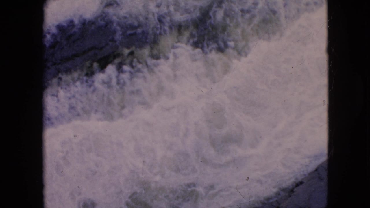 Dense white foam and rough water patterns across the river surface.