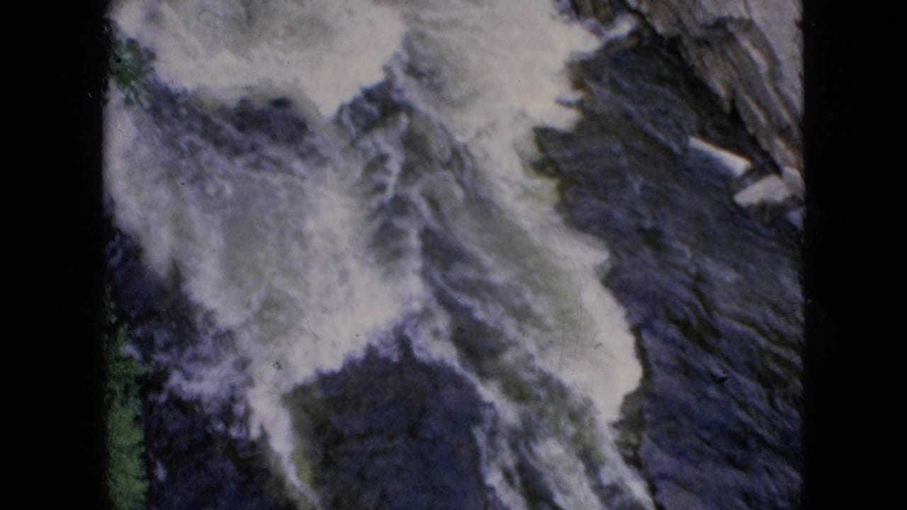 Turbulent Niagara Falls water appears to cascade over dark rock surfaces in 1964 8mm home-movie footage.