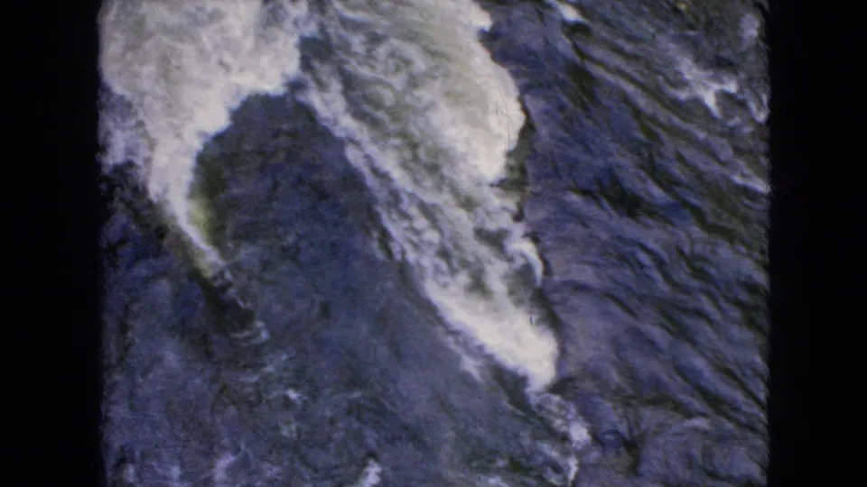 A close handheld view shows foaming water and dark exposed rocks at Niagara Falls, consistent with the supplied 1964 location metadata.
