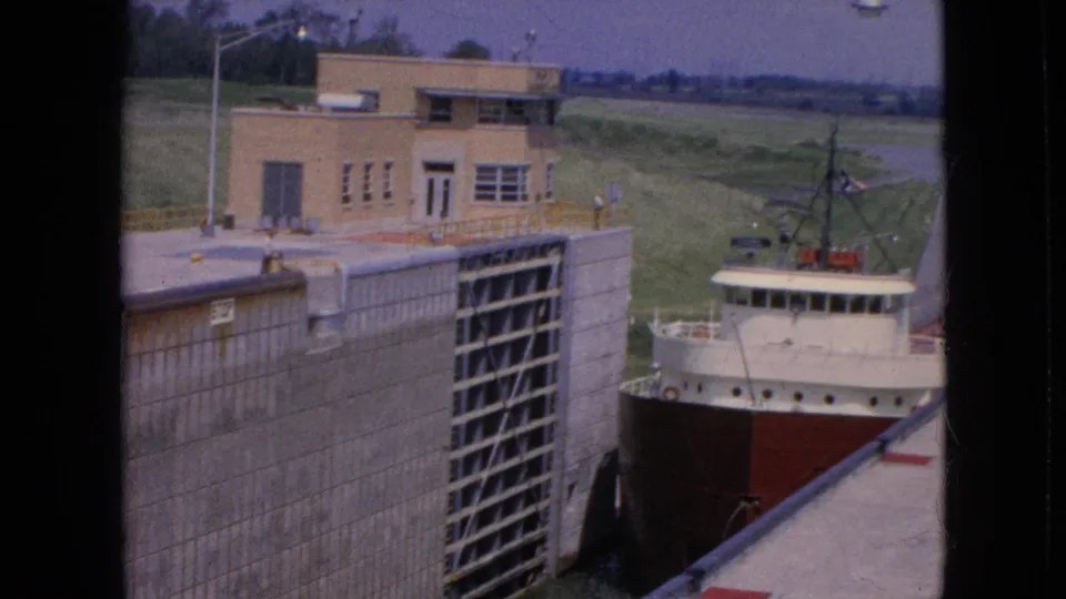 Final 1964 frame shows the ship partly obscured by the lock wall as it moves through the Niagara Falls, New York lock facility noted in the metadata.