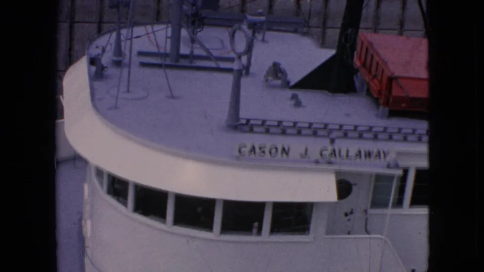 The freighter's bow and bridge fill the frame, with the name Cason J. Callaway partly visible along the curved white hull and deck equipment above.