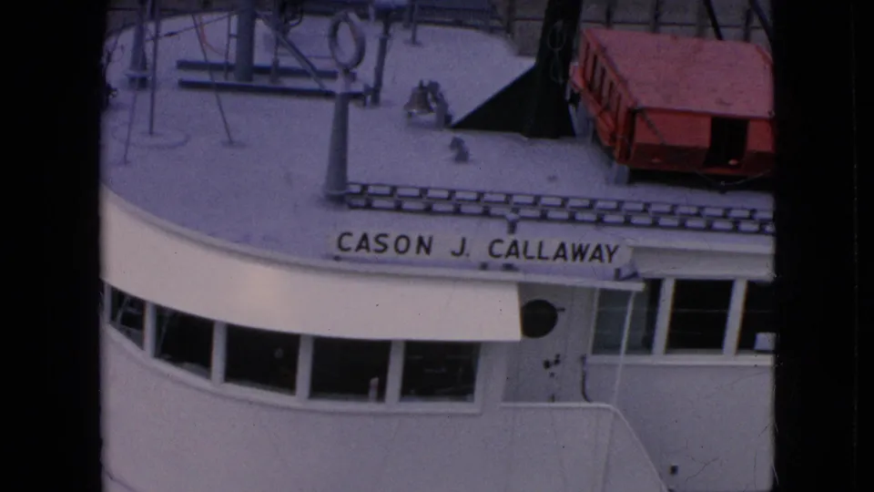The 1964 8mm frame shows the Cason J. Callaway name clearly on the freighter's white bow as the bridge and deck pass through the lock.