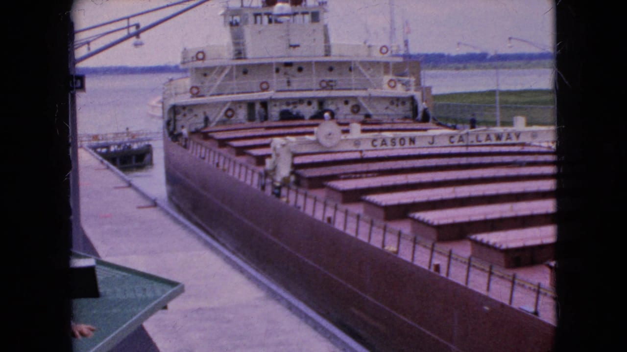 Freighter Cason J. Callaway alongside a dock with open holds.