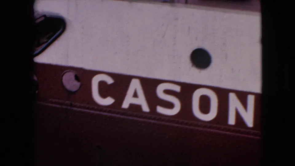 Close 1964 home-movie frame from the Niagara Falls, New York clip showing the red-and-white hull of the boat with large CASON lettering and a round porthole.