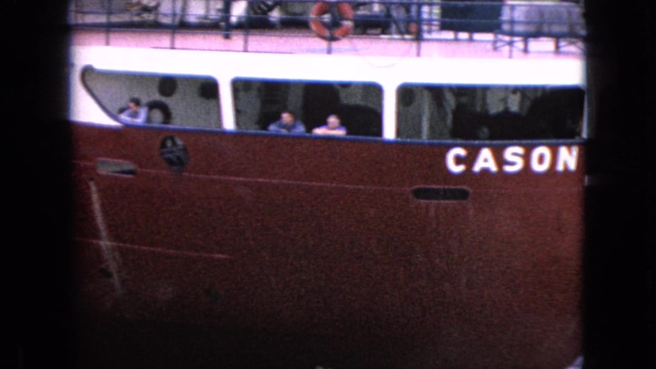 1964 8mm frame from Niagara Falls, New York, showing the red side of the CASON J. CALLAWAY with white cabin windows and people visible aboard.