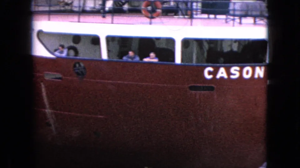 1964 8mm frame from Niagara Falls, New York, showing the red side of the CASON J. CALLAWAY with white cabin windows and people visible aboard.