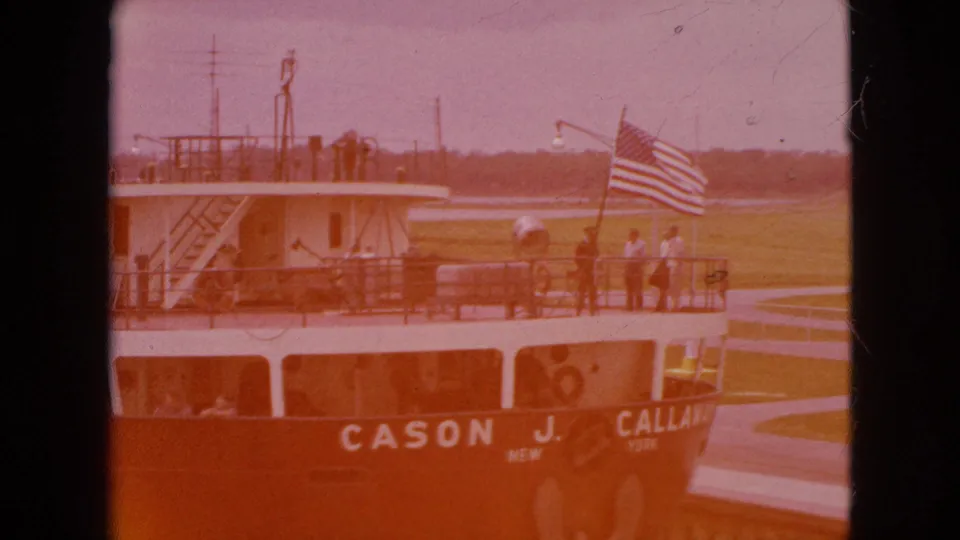 The Cason J. Callaway appears with passengers and an American flag while the 8mm frame is partly obscured by an orange exposure cast.