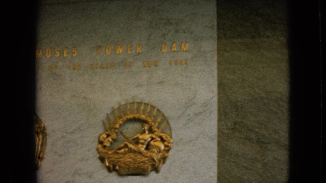 Robert Moses Power Dam inscription with a gold sunburst emblem on polished stone.