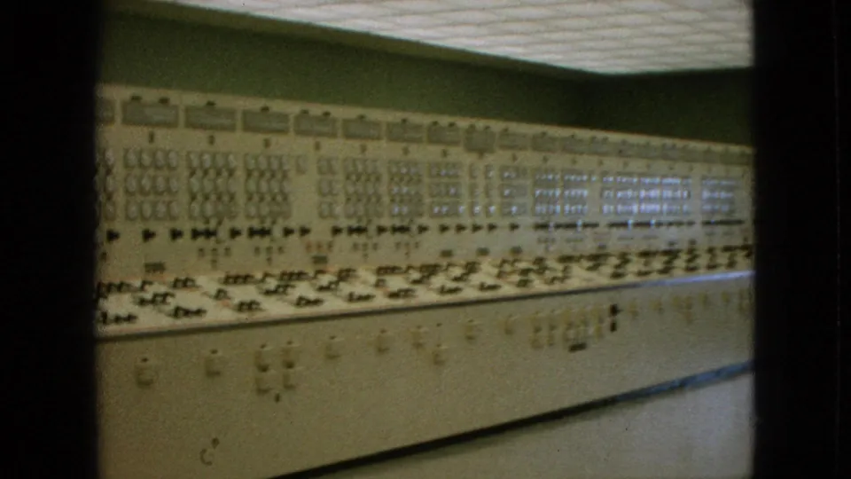 1964 Niagara Falls, New York footage showing a long analog control console with many dials, switches, and indicator panels under a tiled ceiling.