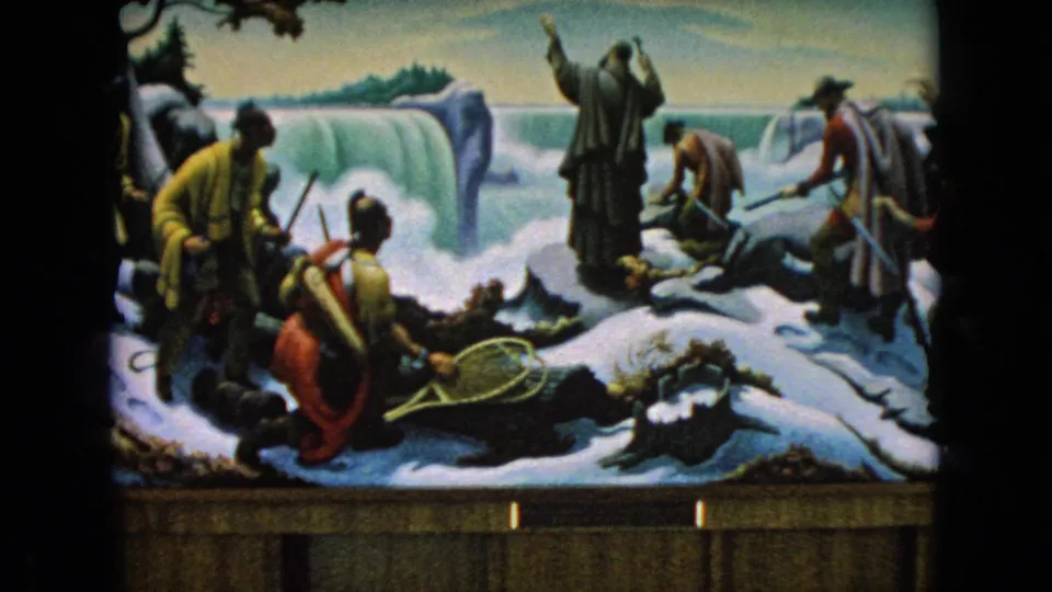 1964 Niagara Falls, New York frame showing the diorama from a slightly wider angle, with snow, a waterfall, clustered explorer figures, and an additional figure at the right edge.