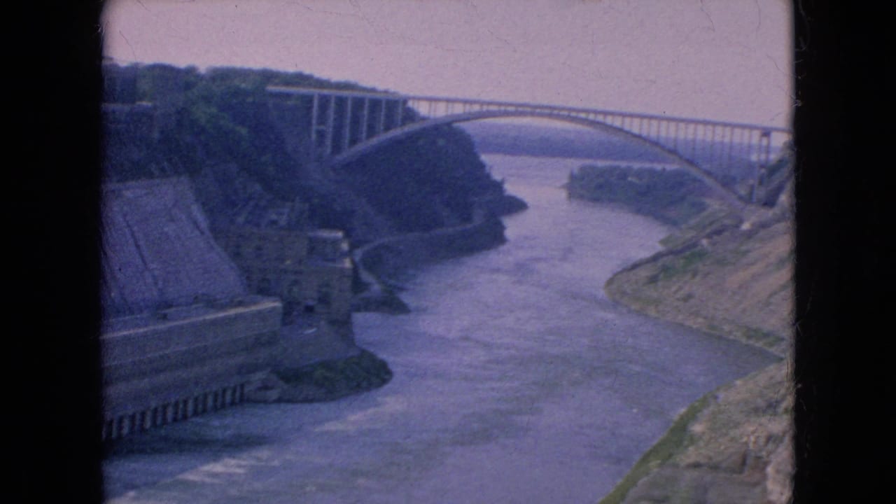 Arched bridge spanning the river gorge with concrete structures along the left bank.