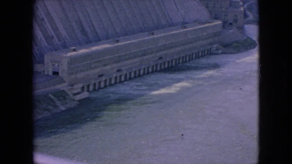 Wide 8mm frame of a concrete dam or hydroelectric structure running along a river, viewed from an elevated position in the Niagara Falls, New York area.