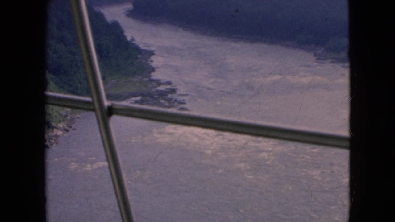 Wide river and wooded gorge viewed through window panes.