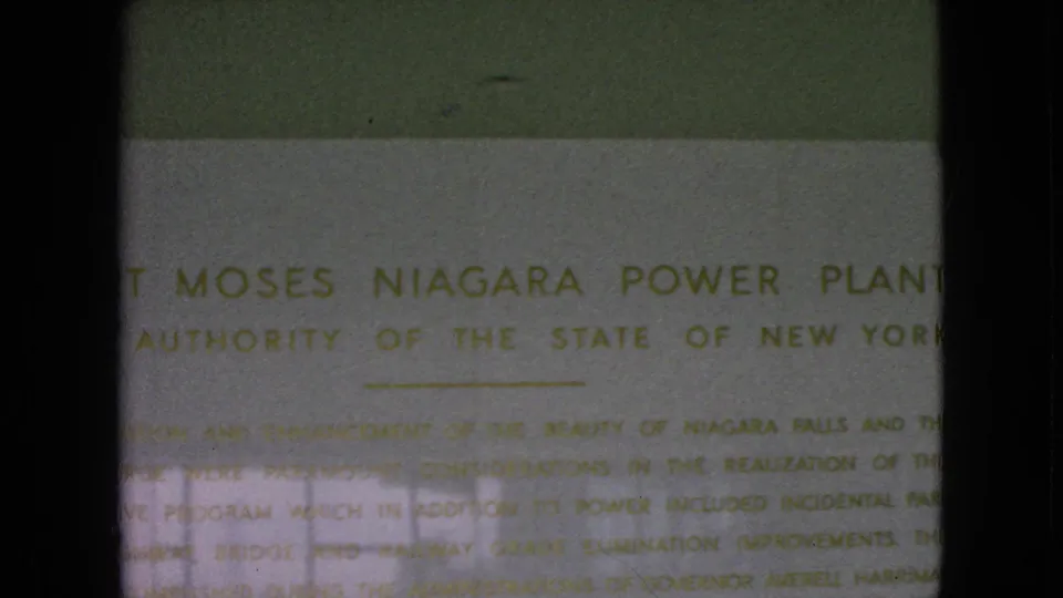 1964 Niagara Falls-area frame showing the Robert Moses Niagara Power Plant plaque and Power Authority of the State of New York wording in faded 8mm color.
