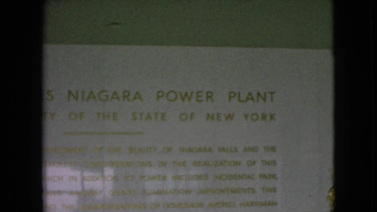 1964 8mm frame with the Moses Niagara Power Plant heading and New York authority wording visible through soft focus and flicker.