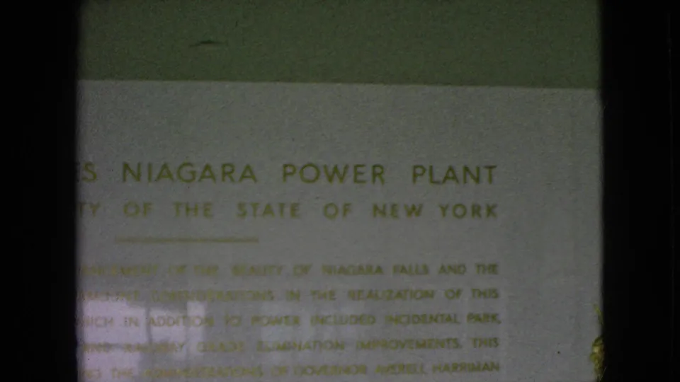 1964 8mm frame with the Moses Niagara Power Plant heading and New York authority wording visible through soft focus and flicker.