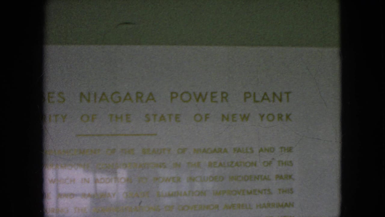 1964 8mm frame ending on the weathered Moses Niagara Power Plant sign, with the public-authority text still partly readable.