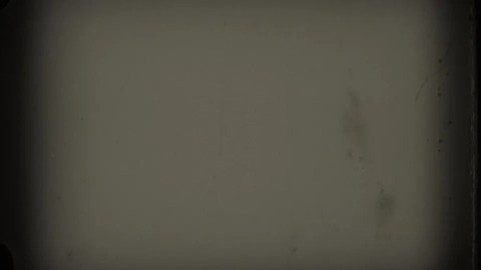 End frame from the 8mm clip showing a largely obscured, darkened film area with soft green-gray exposure and visible frame-edge wear.