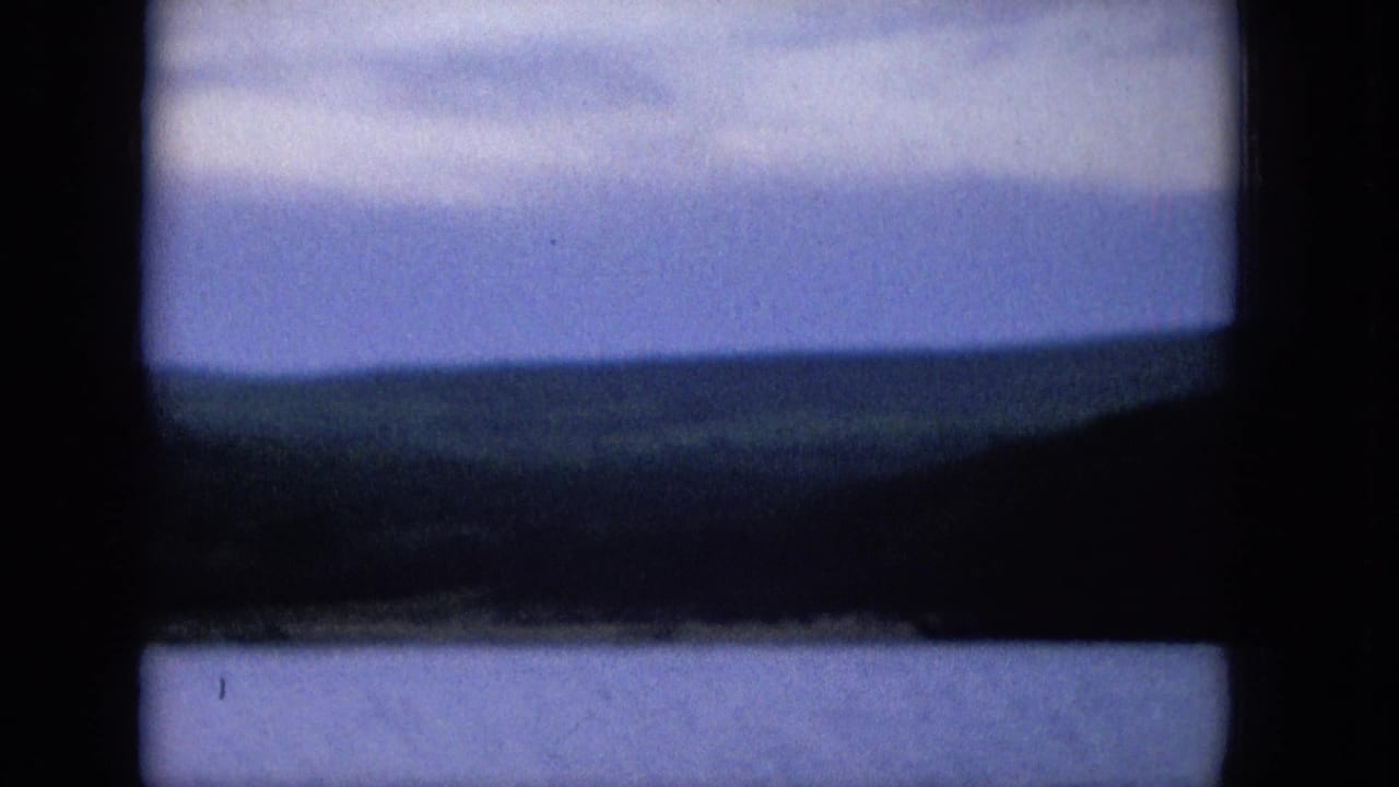 Soft blue horizon with dark hills and sea framed by black 8mm edges.