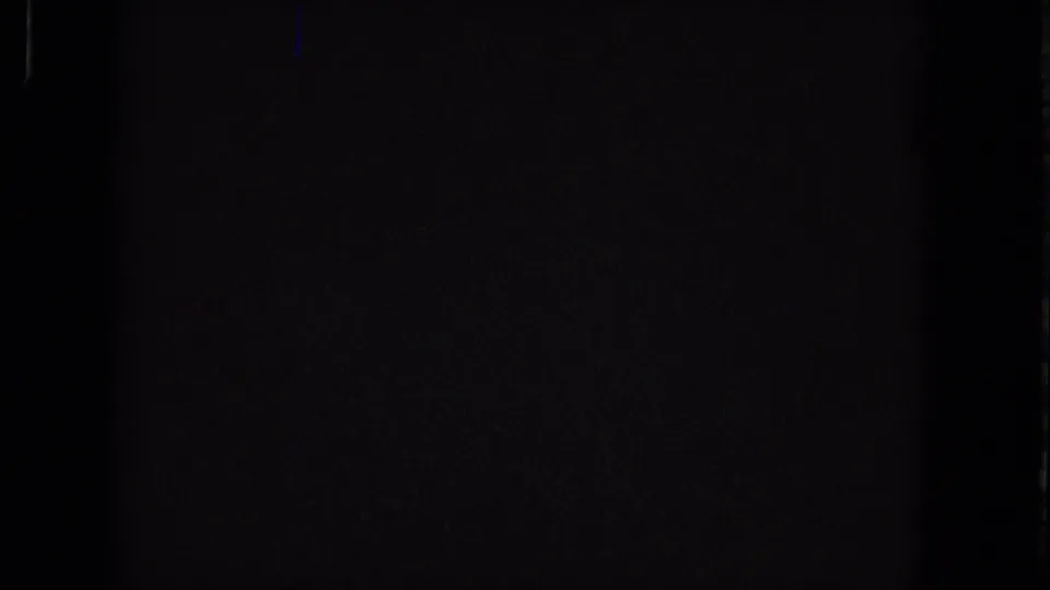 Final near-black Super 8 frame from the 1965 source, with faint grain, a dim blue vertical mark, and no identifiable figures, property, or signage.