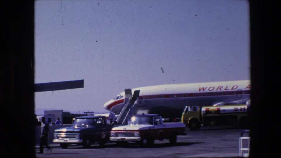 A lower contact-sheet frame shows the side of a World Airways airliner with boarding stairs, a fuel or service truck, pickup trucks, and small figures on the apron.