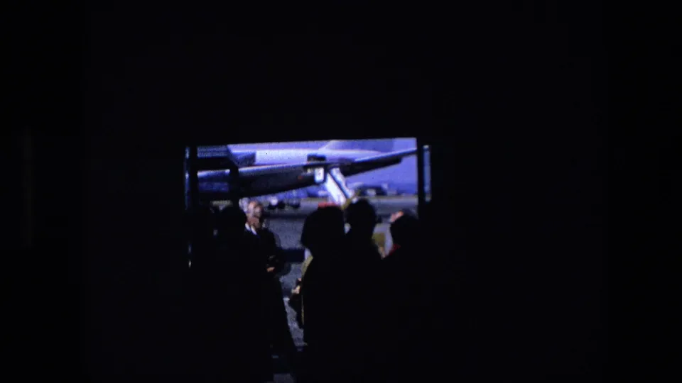 The final frame shows travelers in deep silhouette against the tarmac view, with aircraft structure visible outside in supplied 1967 airport footage.