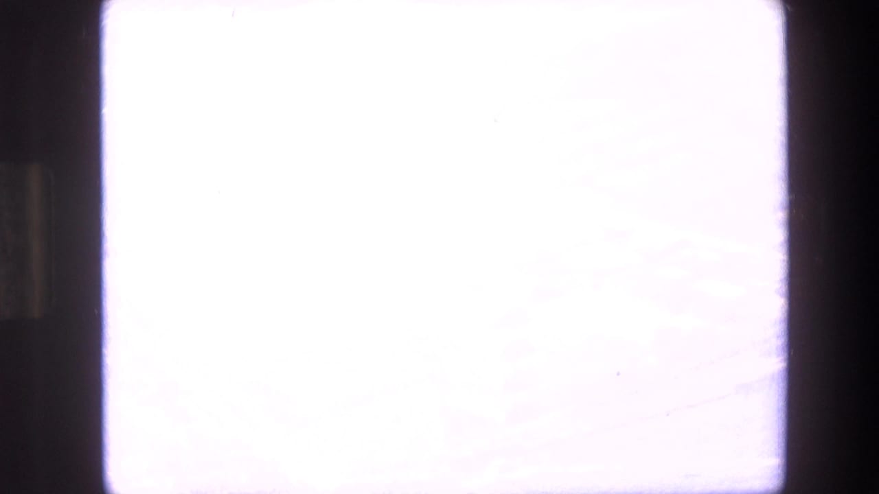 Bright overexposed airplane window area with dark film borders.