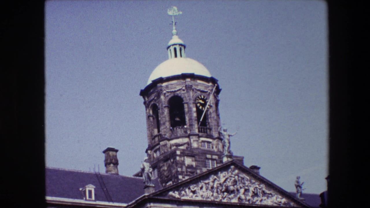 Closer view of the domed clock tower with sculptural details and roofline.