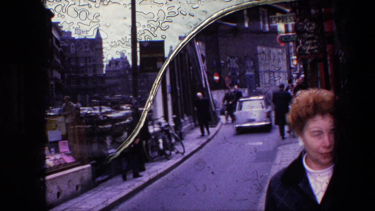 1967 Amsterdam street view with a curved reflective shop window, pedestrians, parked bicycles, and cars on a narrow road.