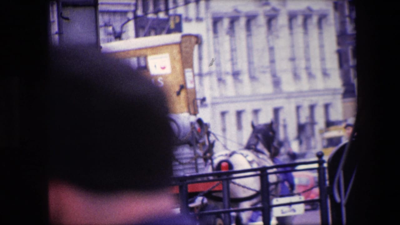 Partially obscured view of a horse-drawn beer cart on a city street.