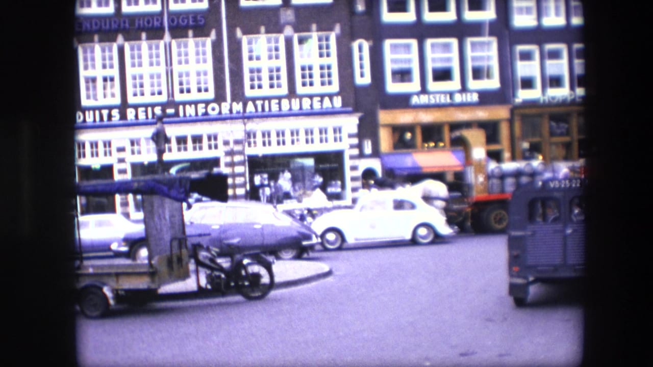 Amsterdam street footage identified as 1967 shows vintage cars, storefronts with Dutch signage, bicycles, and a horse-drawn wagon entering the roadway.