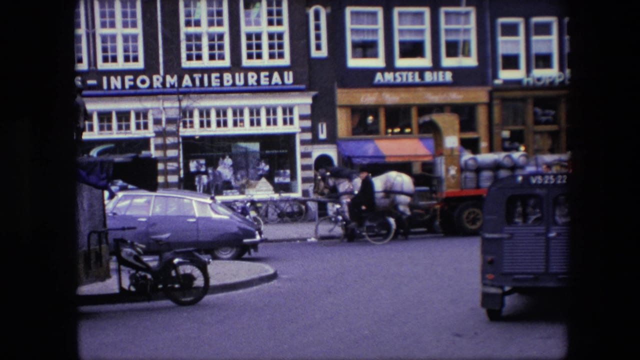 The final frame shows a cyclist, horse-drawn wagon, blue van, cars, bicycles, and Dutch commercial facades in 1967 Amsterdam home-movie footage.