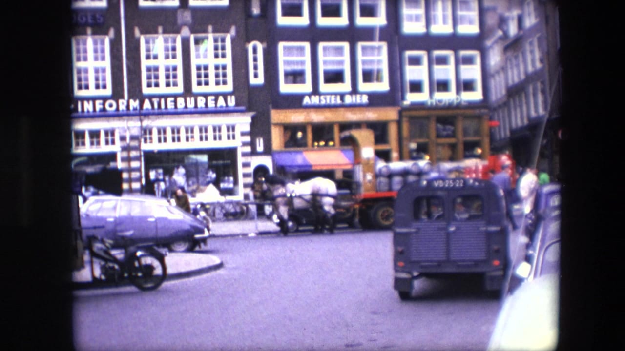 Amsterdam street scene with INFORMATIEBUREAU and AMSTEL BIER signs, period cars, a small van, pedestrians, and a horse-drawn carriage.
