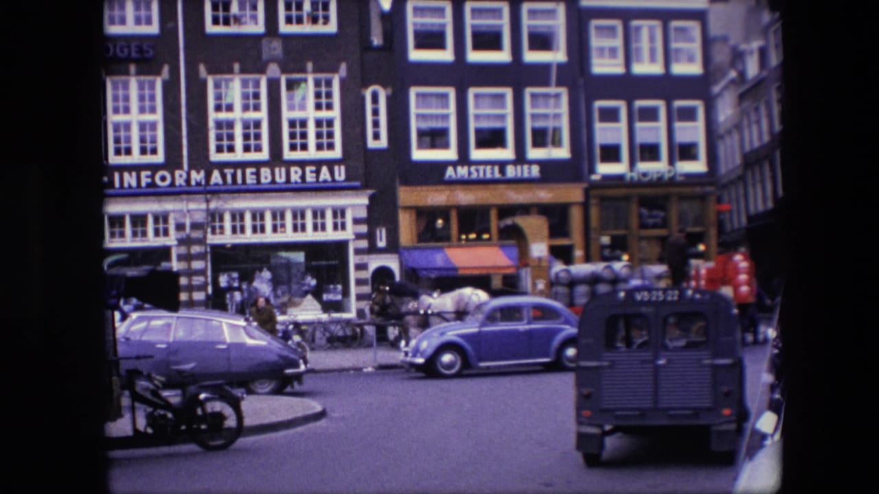 1967 Amsterdam street view with a blue Volkswagen Beetle, a purple sedan, a horse-drawn delivery cart, pedestrians, bicycles, and INFORMATIEBUREAU and AMSTEL BIER signage.