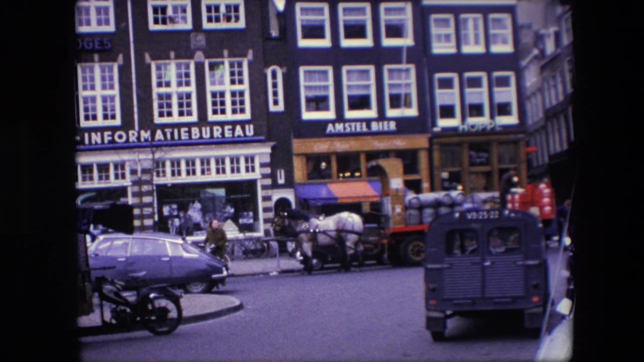 1967 Amsterdam curbside view showing a purple sedan in the foreground, a horse-drawn delivery cart, a dark van, pedestrians, and Dutch streetfront buildings.