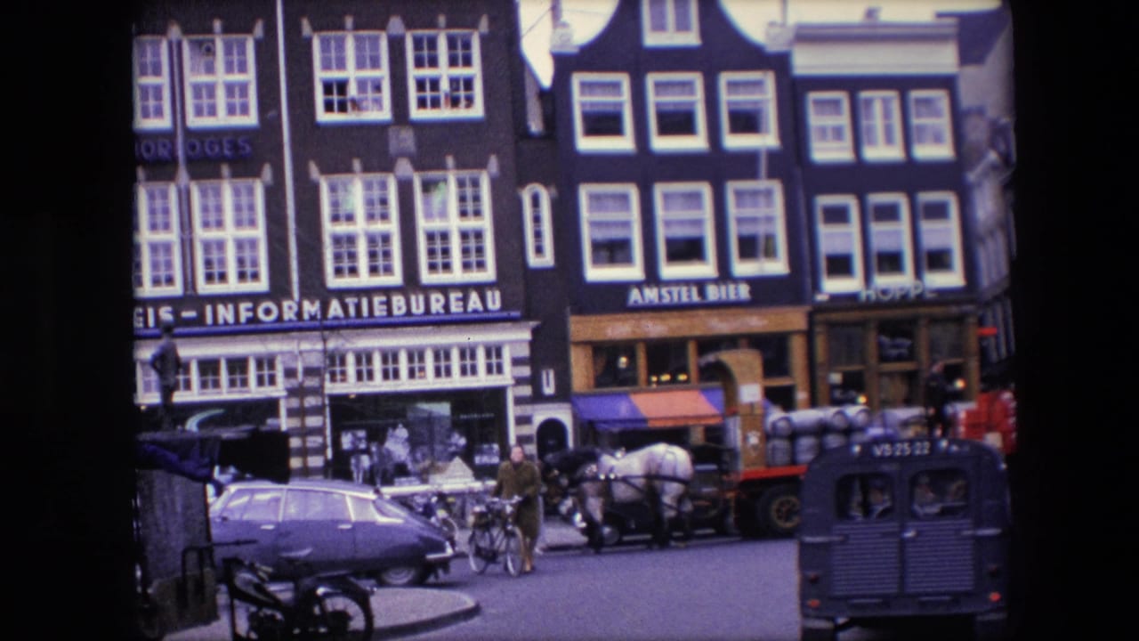 1967 Amsterdam street view with Stichting Reis - Informatiebureau and Amstel Bier storefront signage, period cars, pedestrians, and a horse-drawn cart.