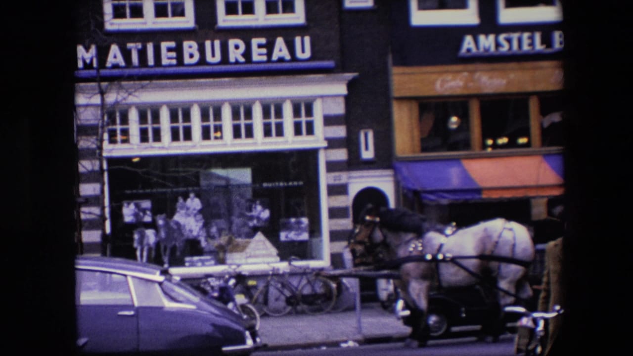 1967 Amsterdam street scene with a light-colored carriage horse near classic cars, bicycles, and storefronts carrying informatiebureau and Amstel Bier signs.