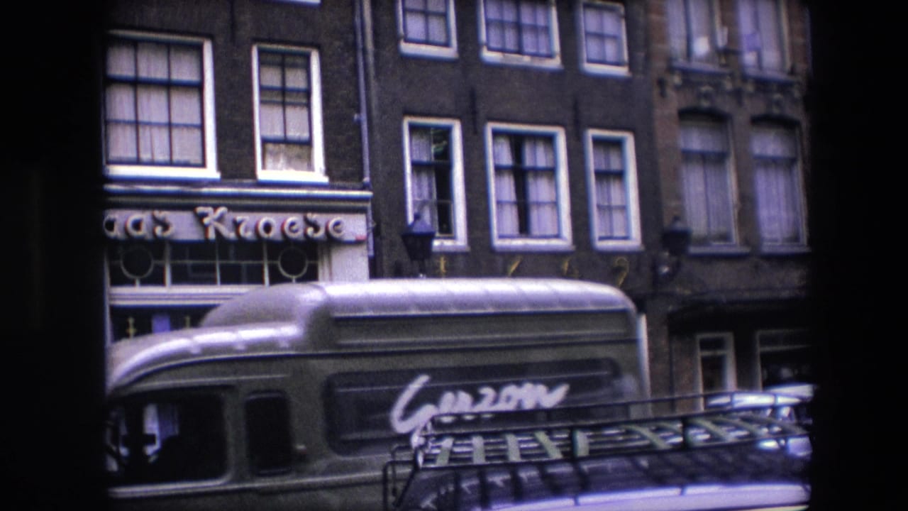A green bus with visible lettering passes along a 1967 Amsterdam street in front of the Kroese storefront and multi-story buildings.
