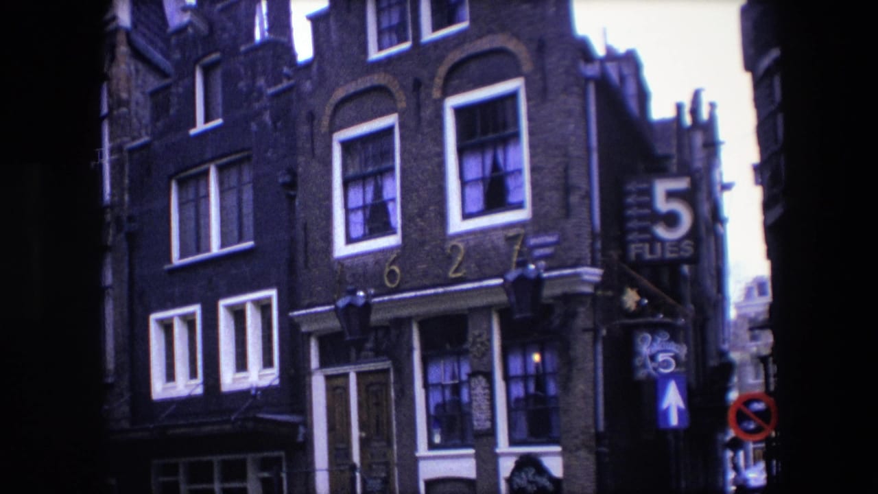 1967 Amsterdam street view showing a brick townhouse facade with white-trimmed windows, address numerals, hanging lamps, and a large 5 Flies sign.