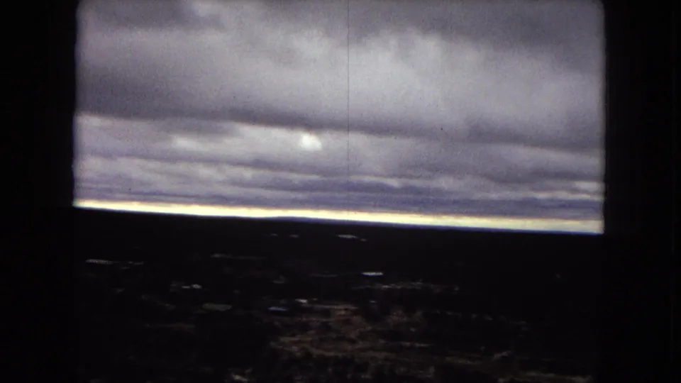1967 8mm footage appears to show a dark storm front over the Grand Canyon, with the canyon mostly in silhouette below a bright horizon line.