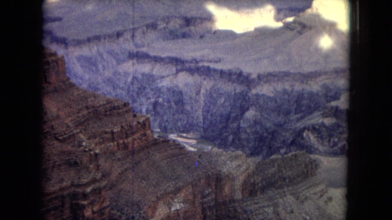 Canyon wall and distant river channel seen from an overlook.