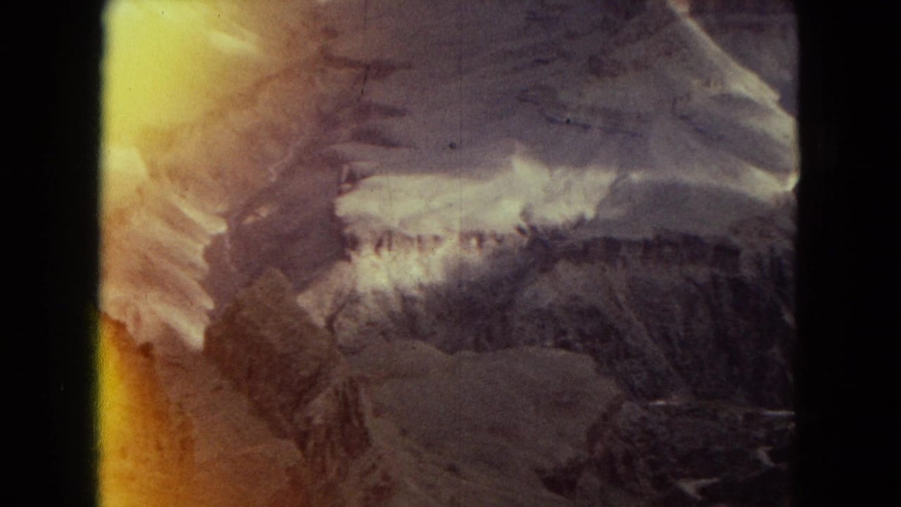 Canyon and mountain view with a strong yellow light leak along the left side.