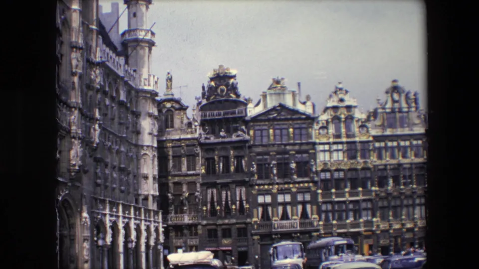 A wider Brussels street view shows ornate historic facades and vehicles near the Grand Place area, with the preceding statue shot partially visible above from the contact-sheet frame.