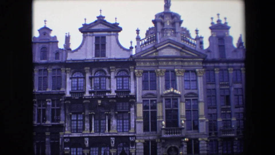 1967 Brussels frame showing a row of ornate historic facades with tall windows, carved details and a slight aged color cast.