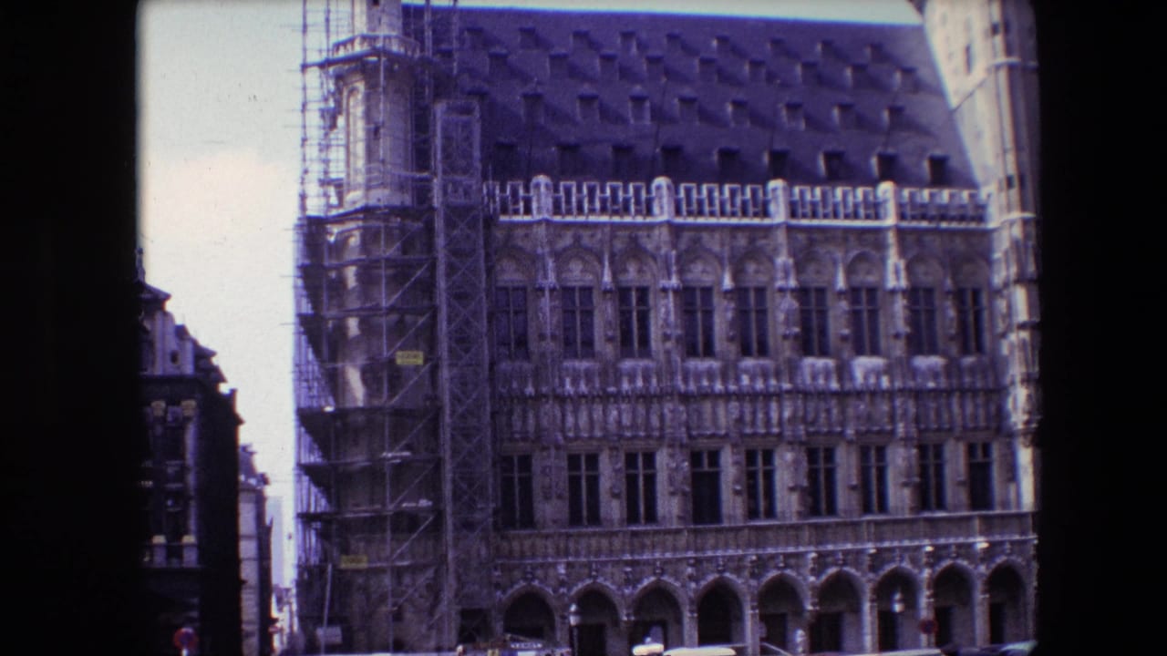 1967 Brussels street-level view of a historic landmark facade, with restoration scaffolding at the left and decorative stonework across multiple window bays.