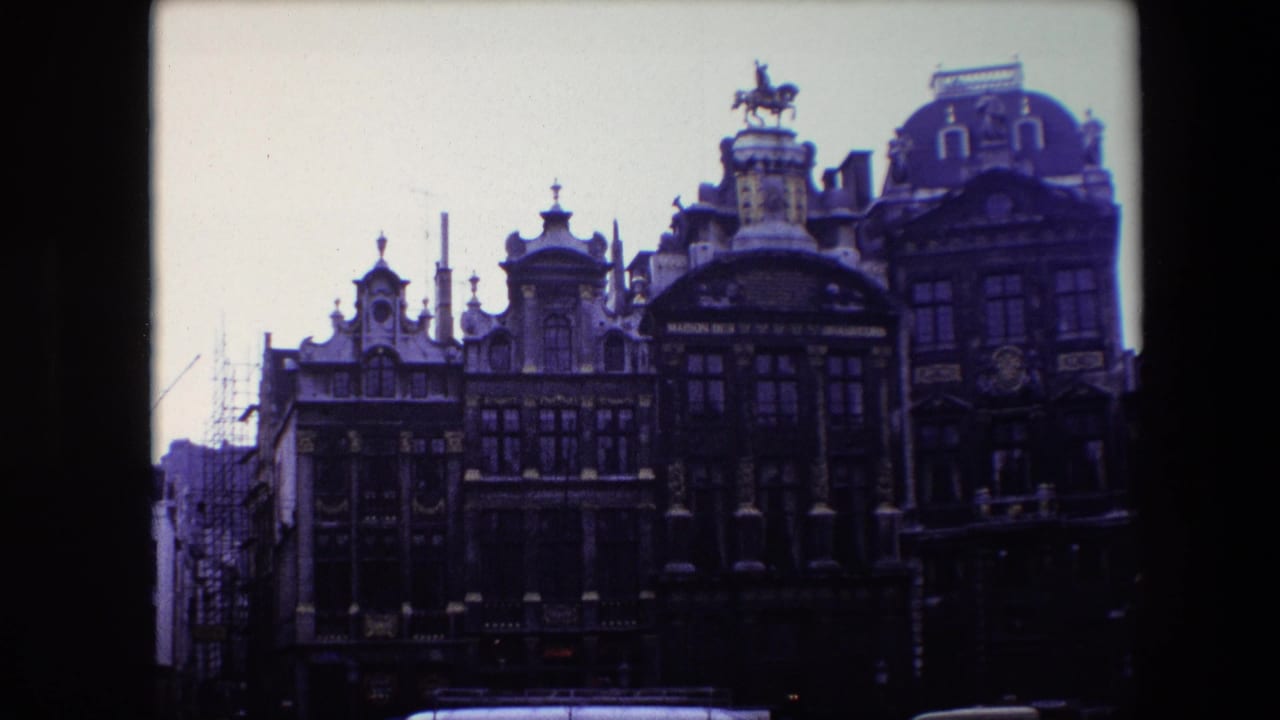 Historic facade with decorative roofline and horse statue near the top.